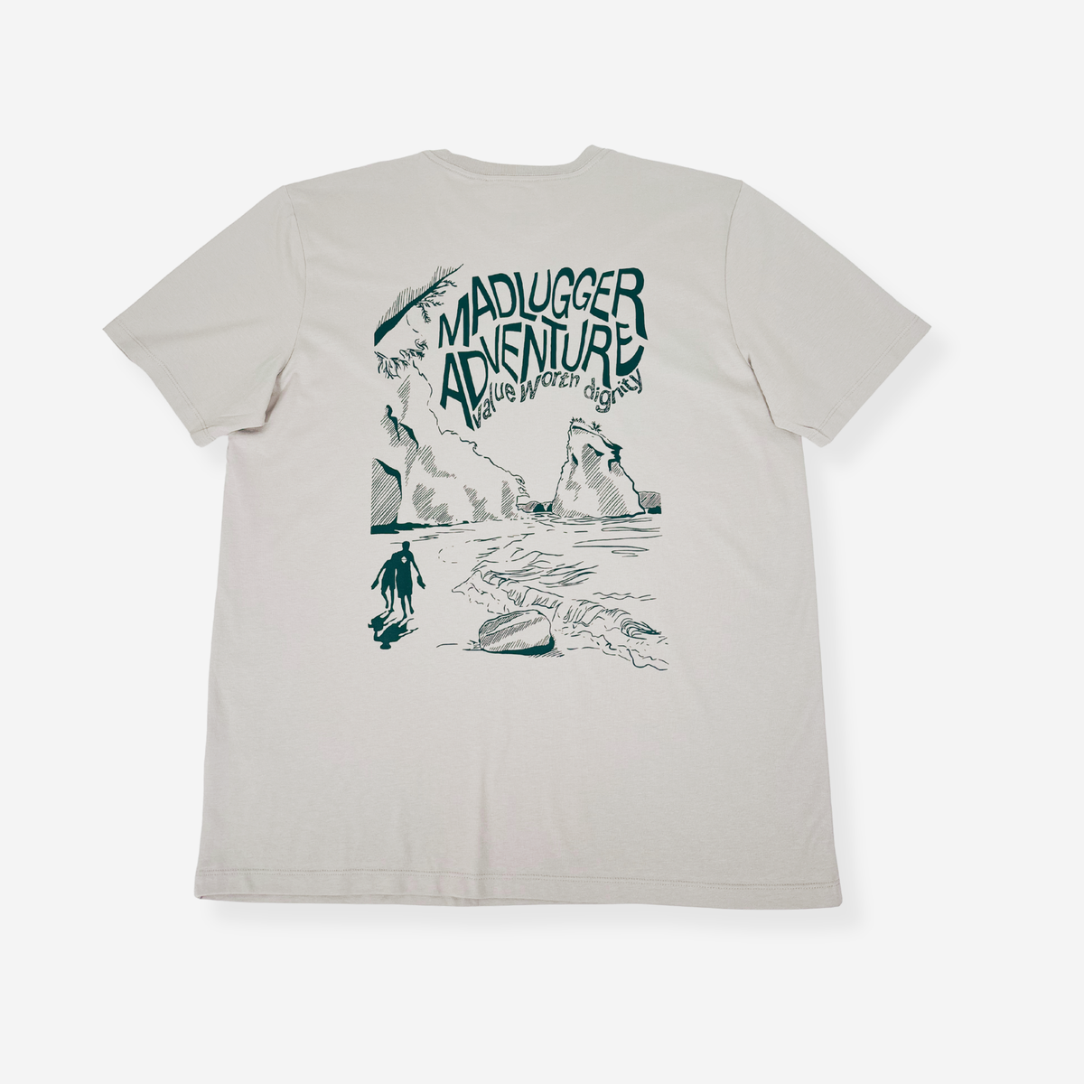A classic stone short-sleeve t-shirt with a white graphic print on the back. The graphic features the text 'MADLUGGER ADVENTURE' in a stylized font above a hand-drawn illustration of a person surfing on a beach with waves and cliffs.