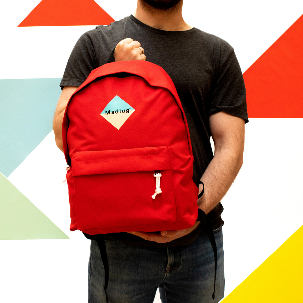 Madlug Classic Backpack in Red. Male model rear view.