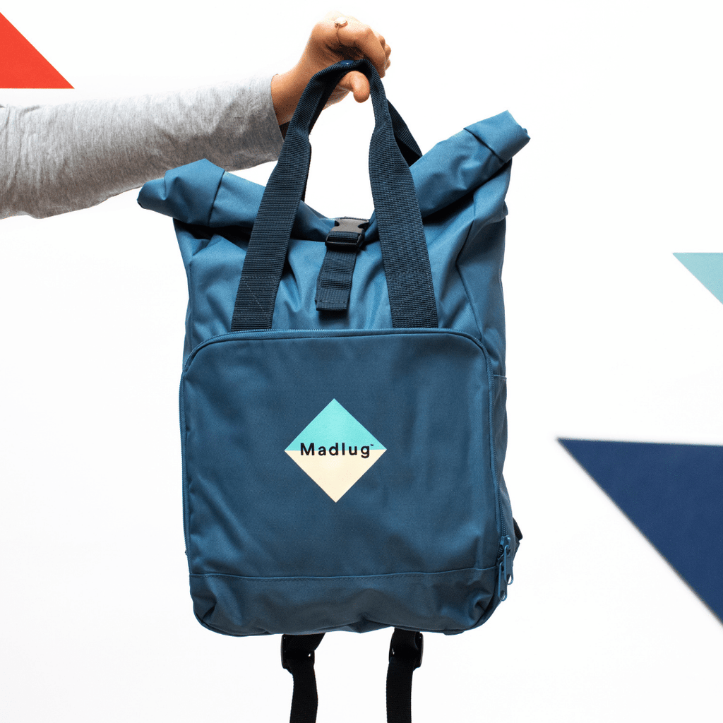 Madlug Roll-Top Backpack in Airforce Blue. Held by straps.
