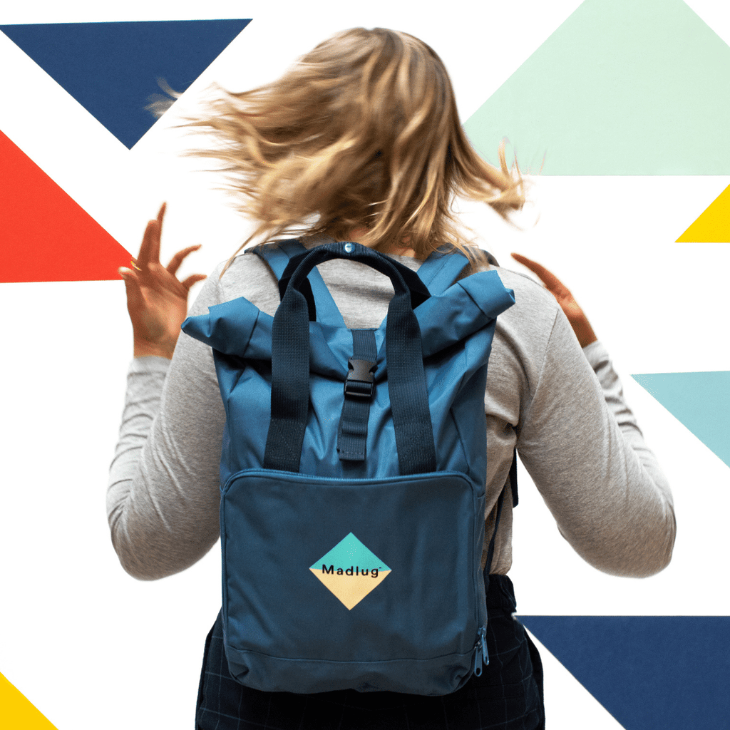 Madlug Roll-Top Backpack in Airforce Blue. Modelled rear view.