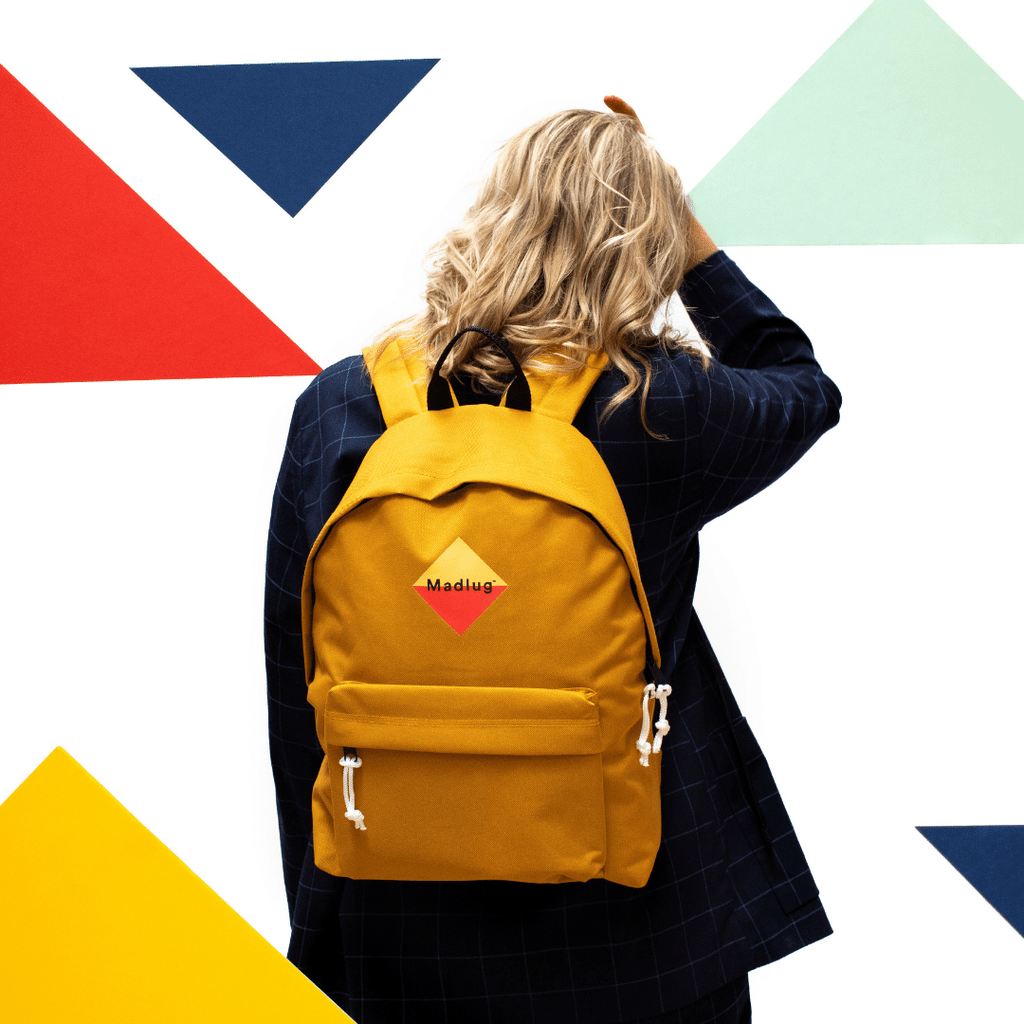 Madlug Classic Backpack in Mustard Yellow. Female model rear view.