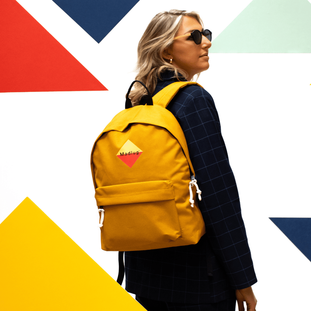Madlug Classic Backpack in Mustard Yellow. Female model side view.