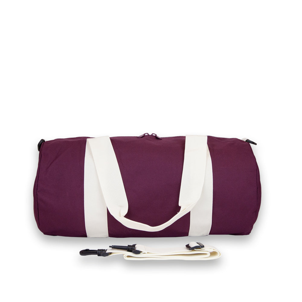 Duffel bag in Burgundy. Rear view showing detachable shoulder strap.