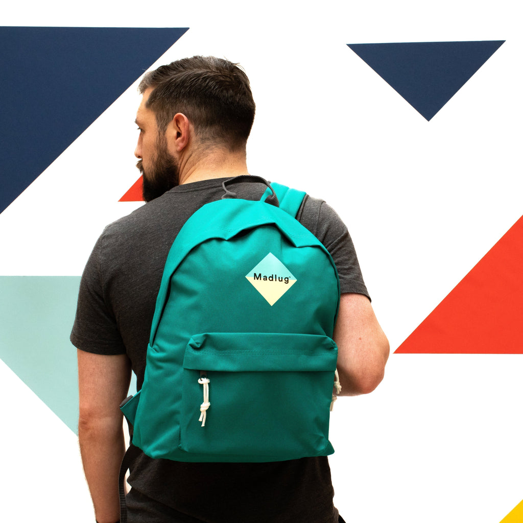 Madlug Classic Backpack in Green. Male model rear view.