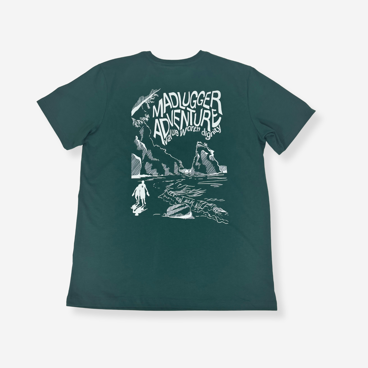 A dark teal green short-sleeve t-shirt with a white graphic print on the back. The graphic features the text 'MADLUGGER ADVENTURE' in a stylized font above a hand-drawn illustration of a person surfing on a beach with waves and cliffs.