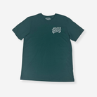 A dark teal green short-sleeve t-shirt with a stylised white graphic on the left chest reading 'MADUGGER ADVENTURE', displayed flat against a light gray background.