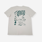 A classic stone short-sleeve t-shirt with a white graphic print on the back. The graphic features the text 'MADLUGGER ADVENTURE' in a stylized font above a hand-drawn illustration of a person surfing on a beach with waves and cliffs.