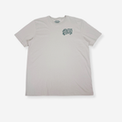 A classic stone short-sleeve t-shirt with a stylised white graphic on the left chest reading 'MADUGGER ADVENTURE', displayed flat against a light gray background.