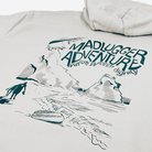 An stone colour hooded sweatshirt featuring a black graphic print of a a wave and cliffs with the text 'MADLUGGER ADVENTURE value worth dignity' and a sketch of cliffs and rocks.
