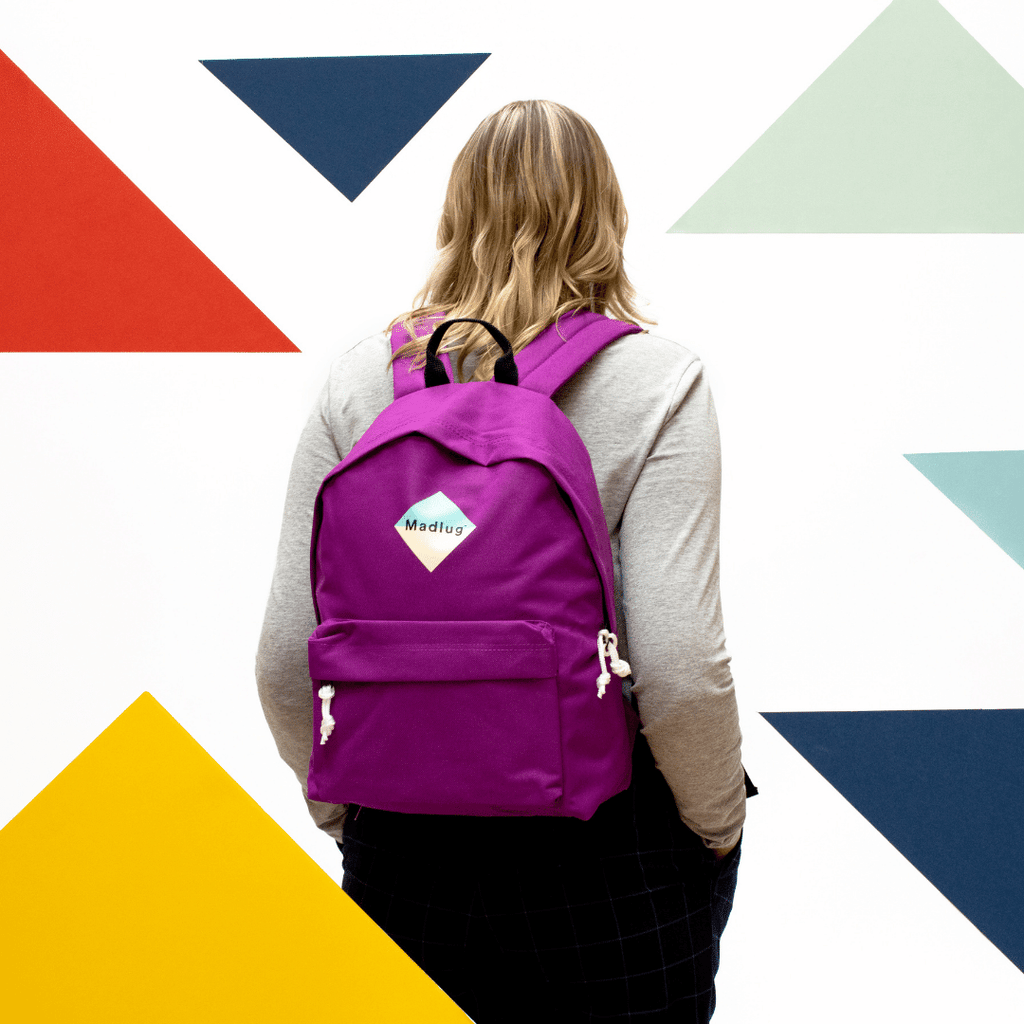 Madlug Classic Backpack in Magenta. Female model rear view.